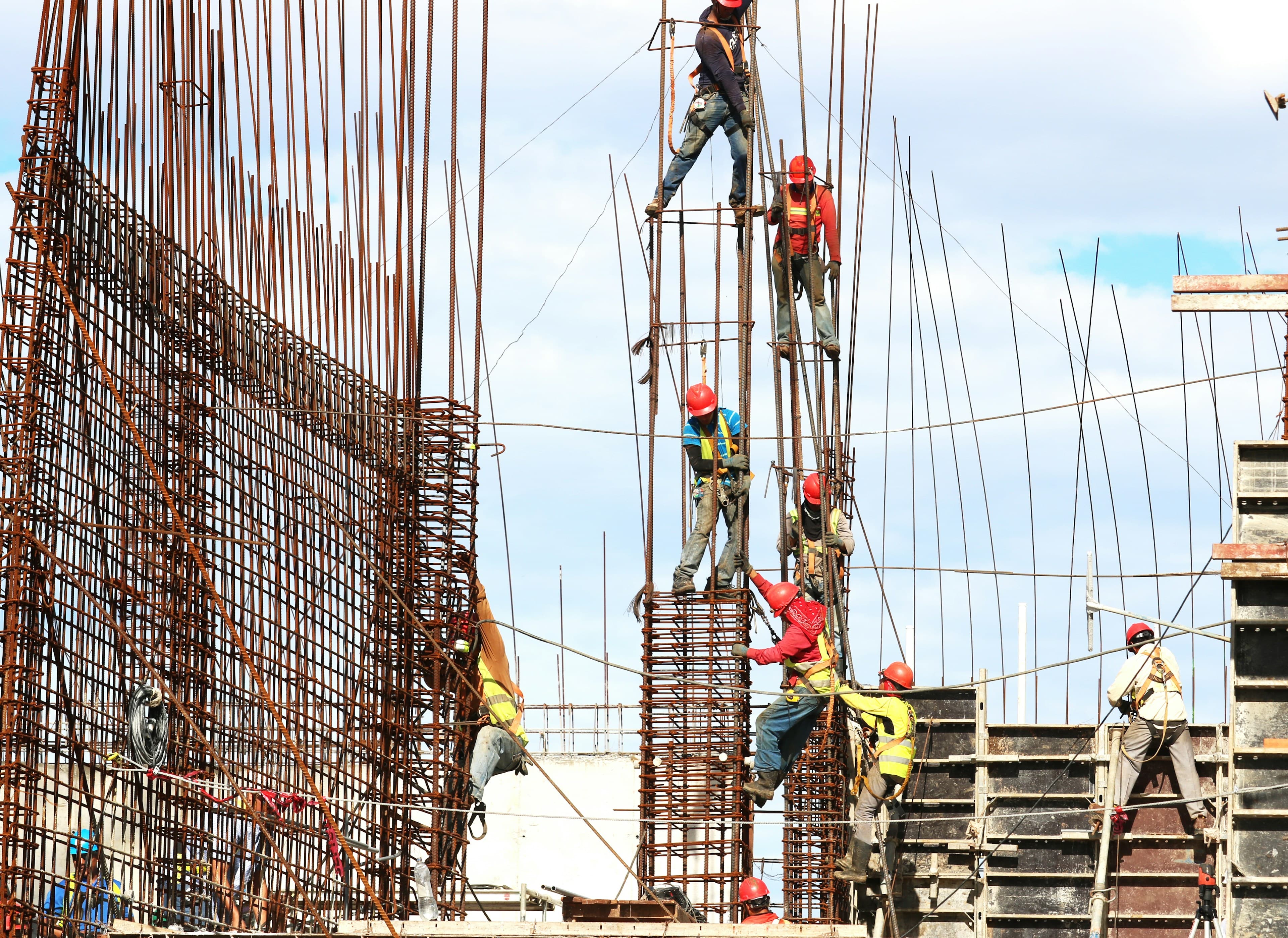 Close view of a red brick wall being laid during construction